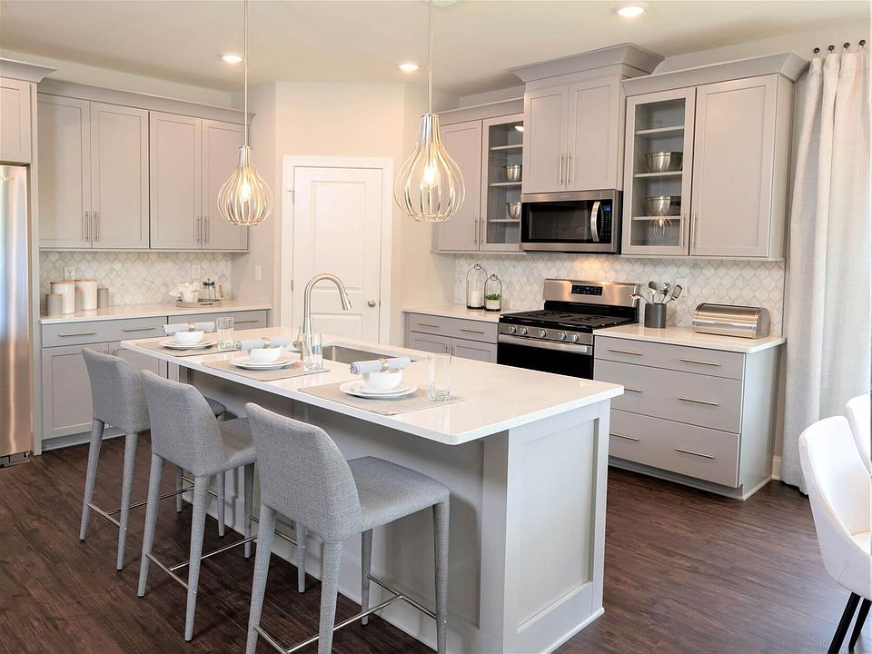 A large kitchen island, walk-in pantry, and plenty of cabinet space.