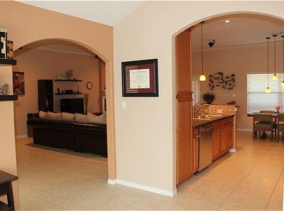 Arched doors from formal dining to kitchen and family room.