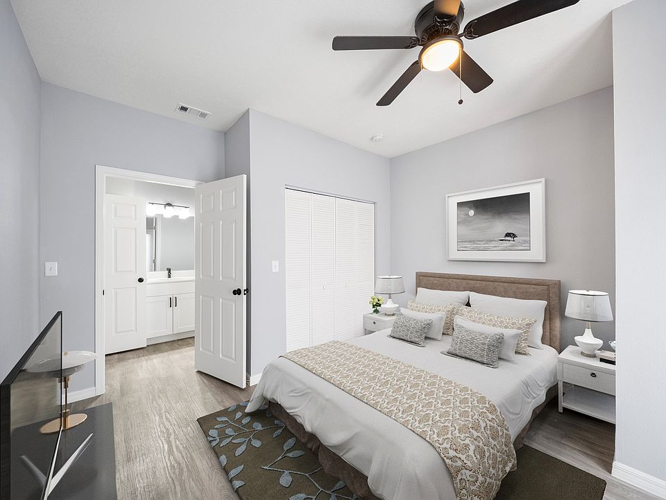 Master bedroom with bathroom mirror and cabinets in view on the left