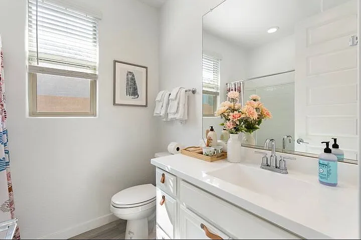 Bath 2: Full guest bathroom with tub/shower combo, single vanity, and toilet.