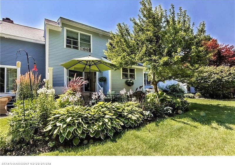 Pretty plantings and patio of this condo.