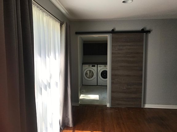 Barn door into laundry room. Washer and dryer included. Door to small deck and yard
