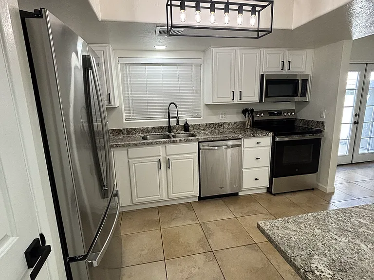 Kitchen view from entry hall. Pocket door to close off if desired