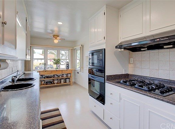 Freshly painted cabinets in bright and well lit kitchen.