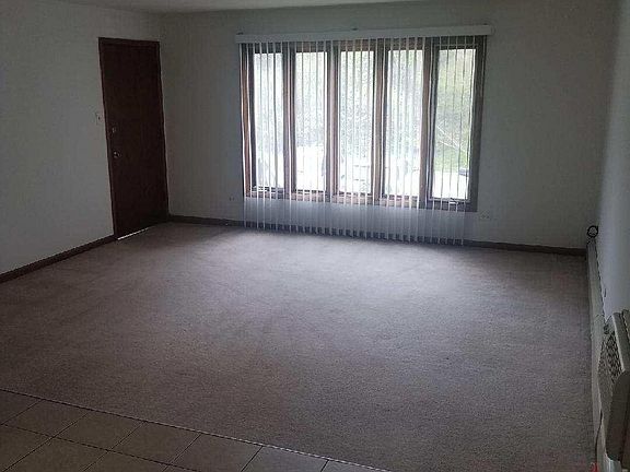 Living Room with entrance door and bay window