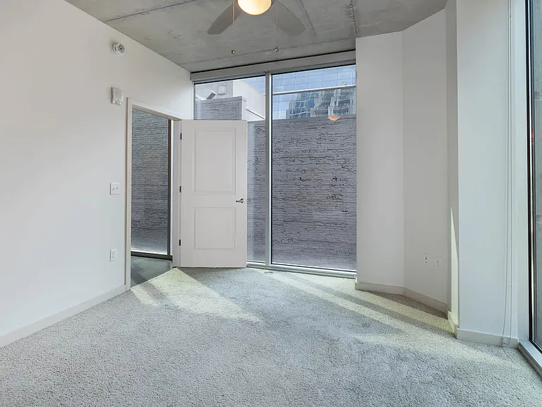 Carpeted Bedroom with Floor-to-Ceiling Windows