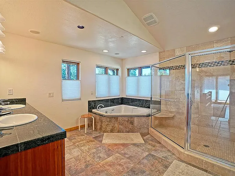 Master bath with jacuzzi, huge shower and forest views