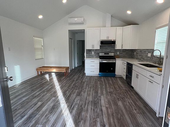 Kitchen/living room with vaulted ceilings and ceiling fan, can lighting