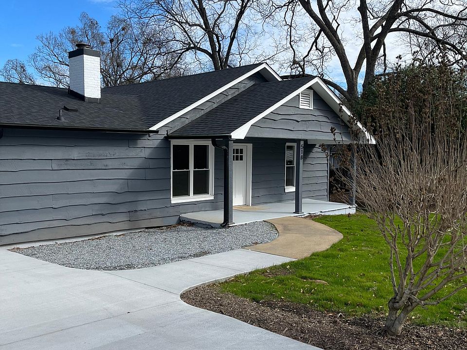 Front porch with concrete driveway and parking spaces