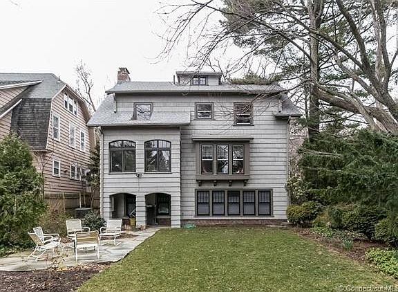 Exterior Back of 75 Autumn St with patio at the left from walkout lower living level