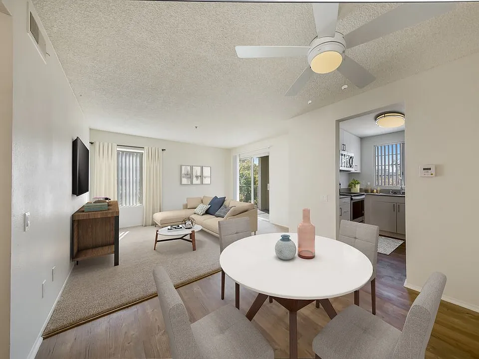Renovated Package Dining area with hard surface plank flooring and living room with carpet