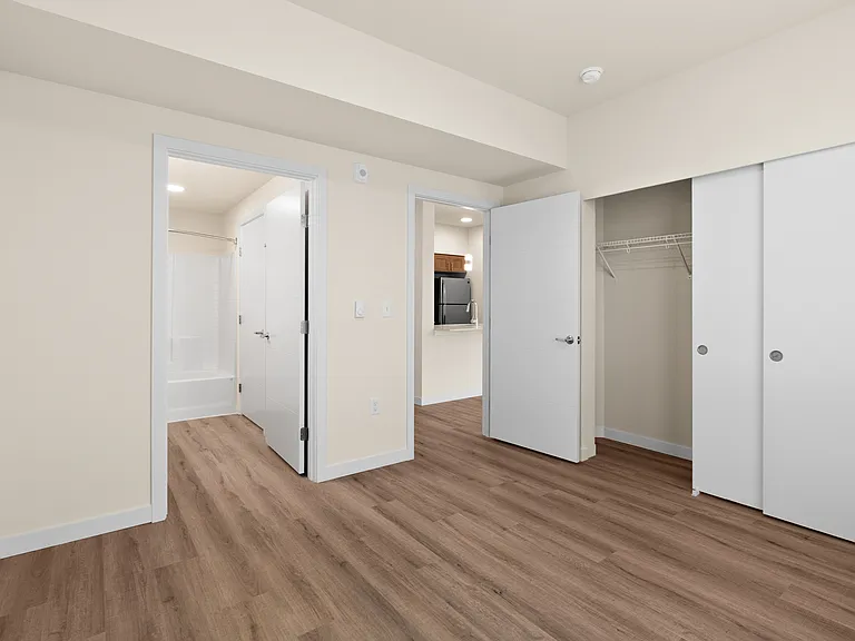 Bright bedroom with ample closet storage and direct bathroom entry. Bright bedroom with ample closet storage and direct bathroom entry.