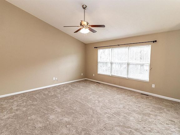 Huge living room with vaulted ceiling and new carpet