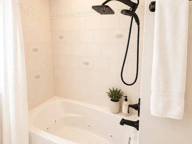 Relax and unwind in the fully renovated bathroom featuring a spacious whirlpool tub, perfect for soaking after a day at Naples Beach. This spa-inspired bathroom offers modern finishes, fresh towels, and a clean, comfortable, relaxing Naples stay.