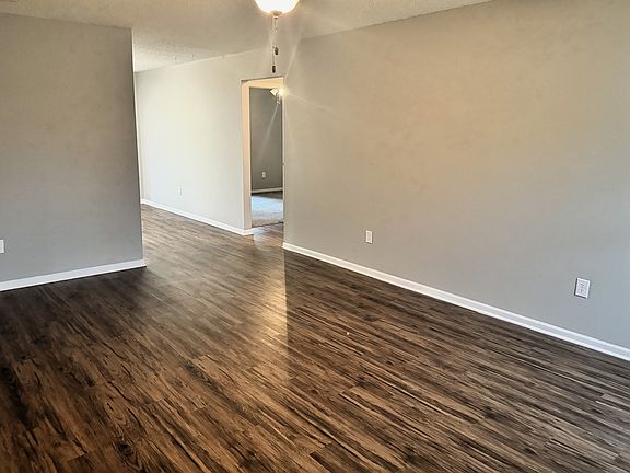 LR LOOKING TOWARDS DR AND HALLWAY FOR BEDROOMS