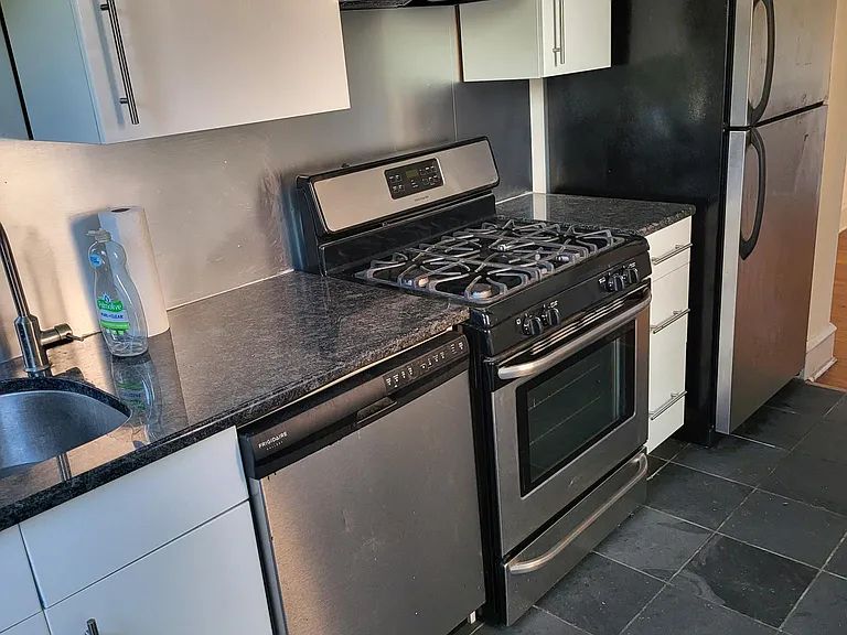 Updated kitchen with Euro cabinets and full size ss appliances, slate floor.