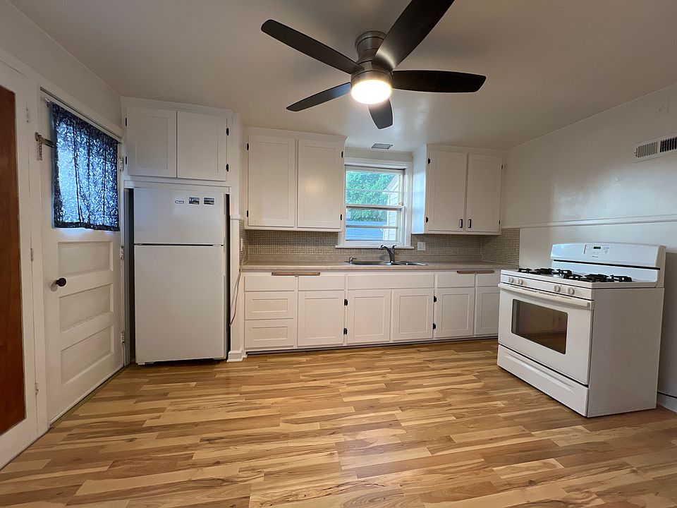 Remodeled Kitchen. Refinished cabinets, new faucet, new faucet, and new ceiling fan.