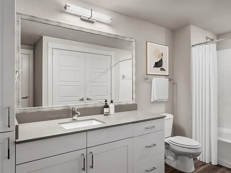 Spacious Bathroom with Large Vanity and Bright Lighting