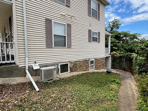 Walkway at right of house to apartment entrance