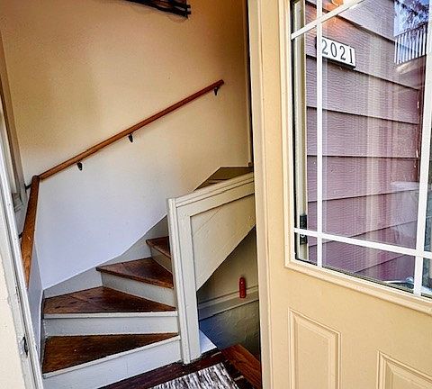 Private entry: Stairs leading down to basement (w/ washer/dryer); upper stairs lead to unit door.