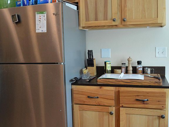 Large matching fridge with added counter top and storage.
