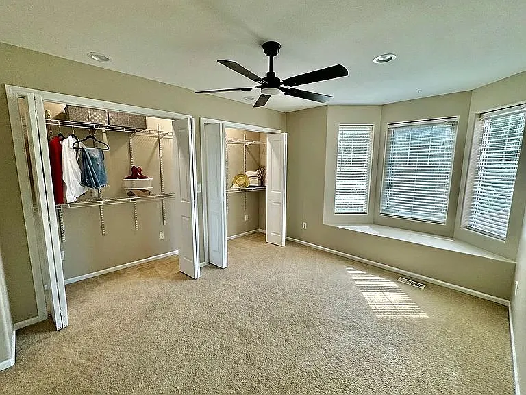 Bedroom one, large double closet and bay window with seating, all rooms have ceiling fans