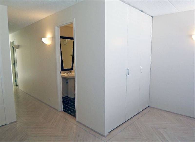 A gracious sunny Foyer with pickled wood floors.