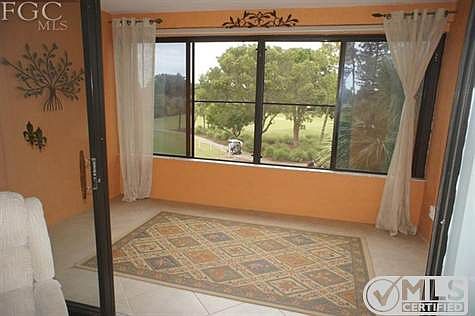 View of 8th Fairway for golf course from lovely enclosed Florida room.