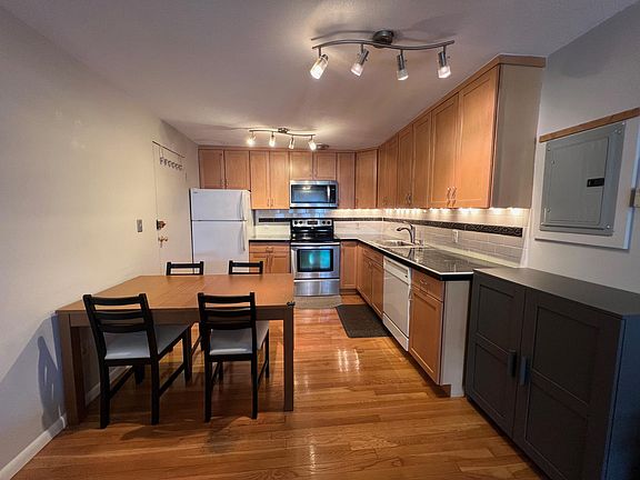 Open kitchen with built-in ventilation and dining area