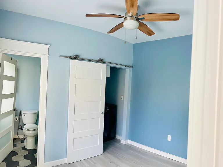 Bedroom with extra high ceilings, ceiling fan and walk-in closet