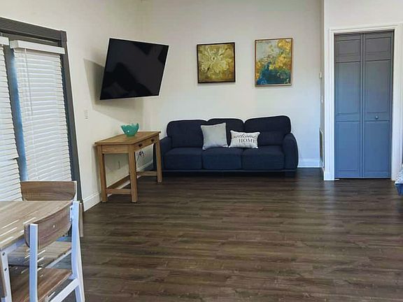 Cozy living room with a large sofa, cushions, and art pieces.