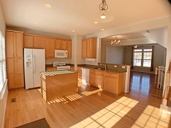 Bright kitchen opening up to living and dining areas