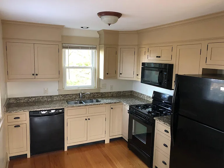 Kitchen with granite countertops, gas range, and brand new Bosch dishwasher
