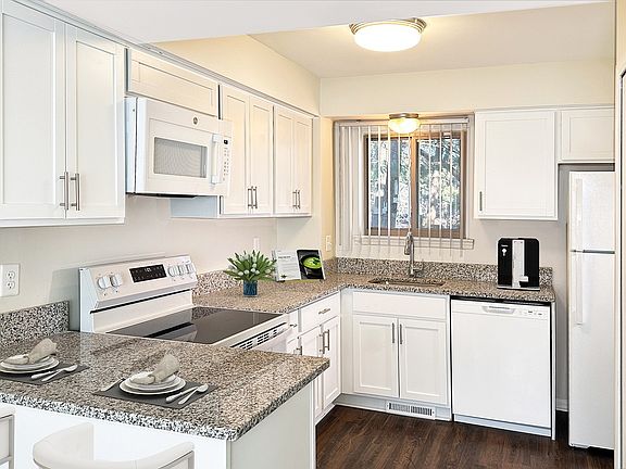 Upscale and updated super luxury kitchen with easy care wood plank flooring and cheery window.