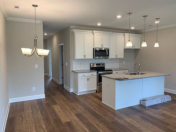 Modern kitchen with new appliances, including refrigerator.