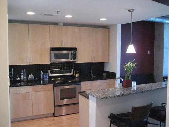 Kitchen w/maple cabinets, S/Steel appliances, granite counters breakfast bar.