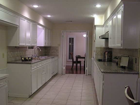 Granite countertops with tumbled marble backsplash