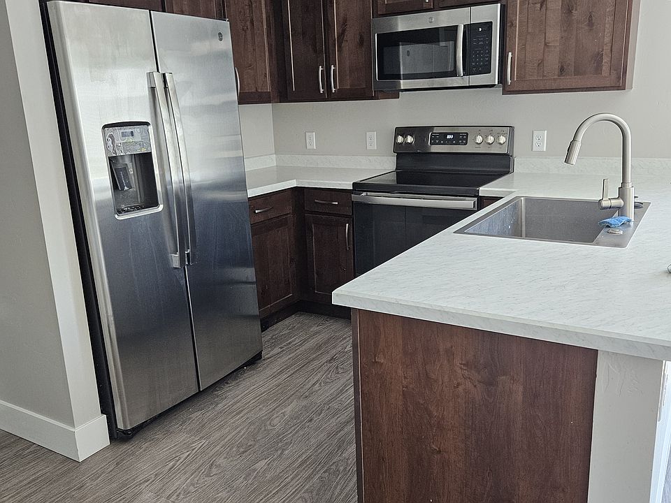 Kitchen with stainless appliances, plus microwave, disposal and dishwasher.