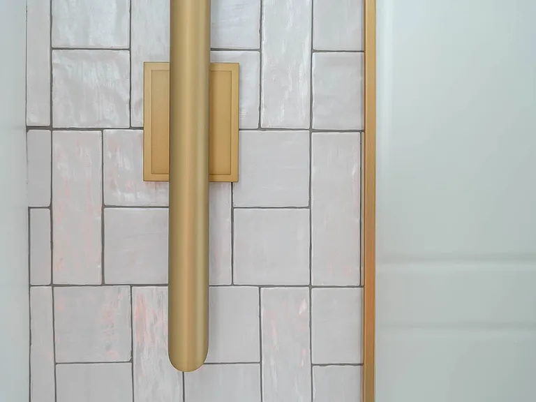 Close-up of modern brass torchiere style sconce.