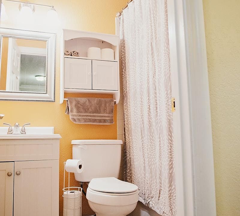 Bathroom #1: stylish orange with new vanity, mirror, and toi