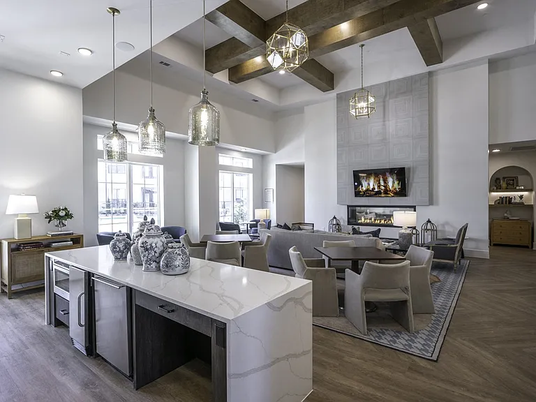 Unwind in style at Modera Walsh's expansive clubhouse, boasting a cozy fireplace and versatile entertainment space.
