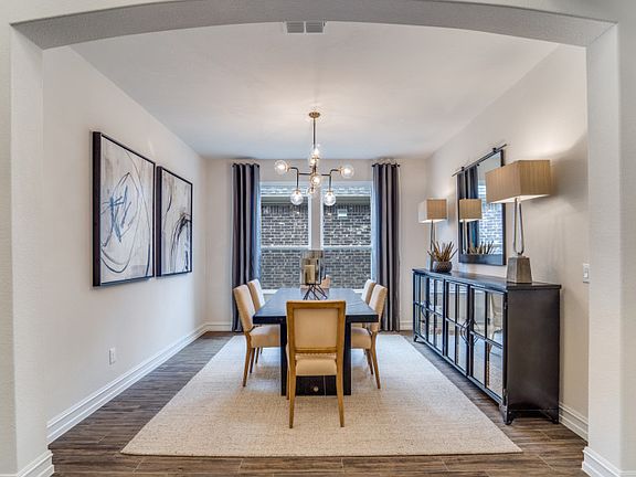 Model Representation - Formal dining area just off the foyer with space to seat the whole family
