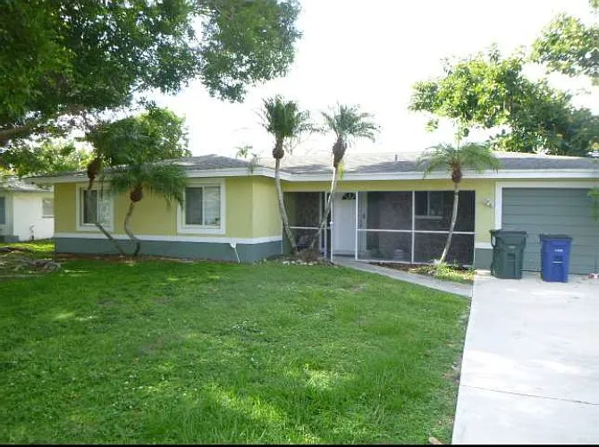 Front house with schreened enclosure and new stucco exterior