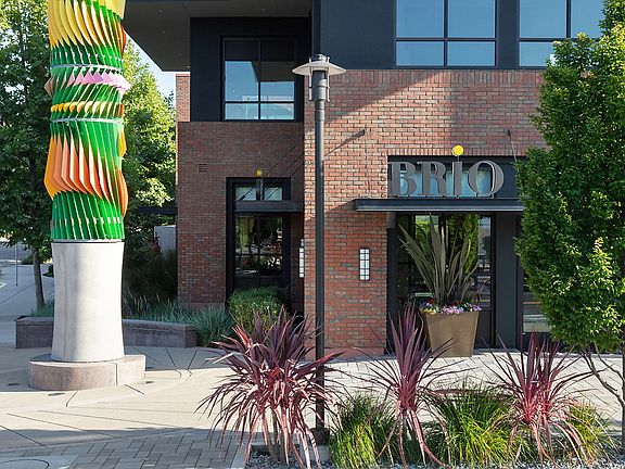 Building with brick style exterior and landscaping.