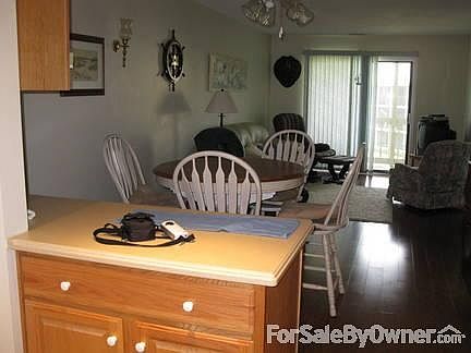 Kitchen open to dining / living room : Kitchen opens to dining & living room. Sliding doors lead to 