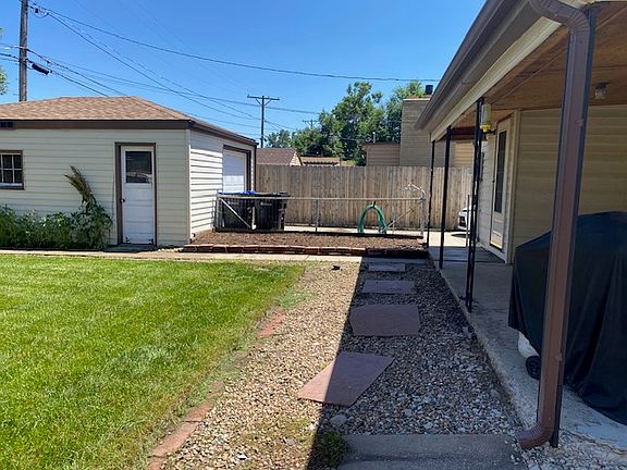 Back porch, yard, and detached one-car garage