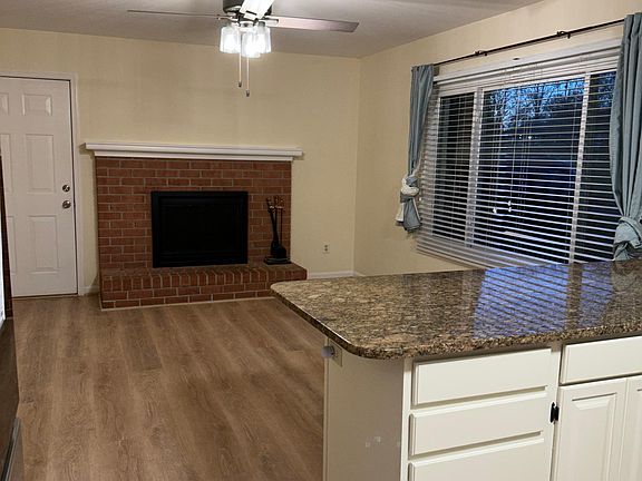 Beautiful brick fireplace and sitting area off of kitchen.