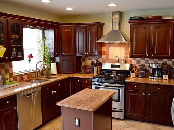 Kitchen - Pull-out garbage next to dishwasher. Pull-outs through-out kitchen + lazy Susan in corner & top corner cabinet