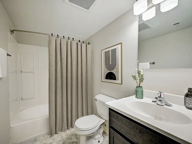 3 BR 2 BA Recently Renovated Townhouse Style Apartments featuring New gray carpet, Neutral paint scheme, Premium hardwood-style flooring, Neutral paint scheme, Upgraded light fixtures, New cabinets, Matching stainless steel appliances, Washer/Dryer, Air c