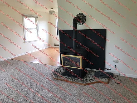 Living room carpeted. Nat. gas fireplace heats well insulated home.